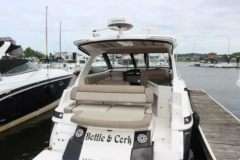 Slide: The Image of 2014 Regal 35 Sport Coupe docked, featuring spacious seating and modern design. - 14