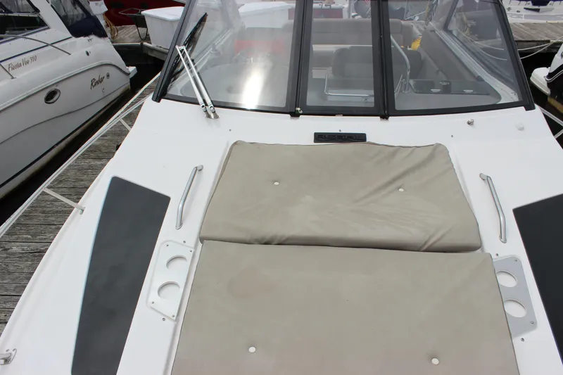 Slide: The Image of 2014 Regal 35 Sport Coupe boat with cushioned deck and windshield in marina. - 15