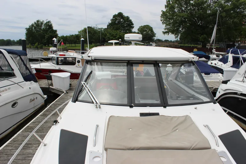 Slide: The Image of 2014 Regal 35 Sport Coupe docked at marina with other boats. - 18