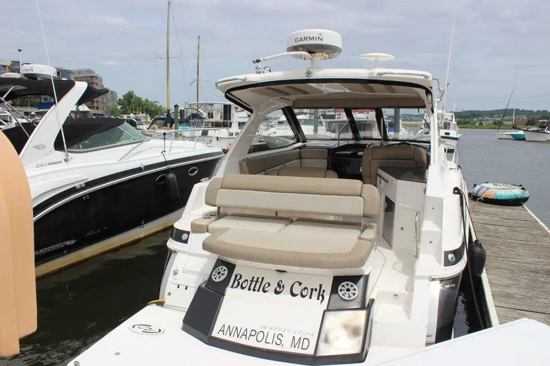Slide: The Image of 2014 Regal 35 Sport Coupe docked in Annapolis, MD, featuring spacious seating and Garmin equipment. - 19