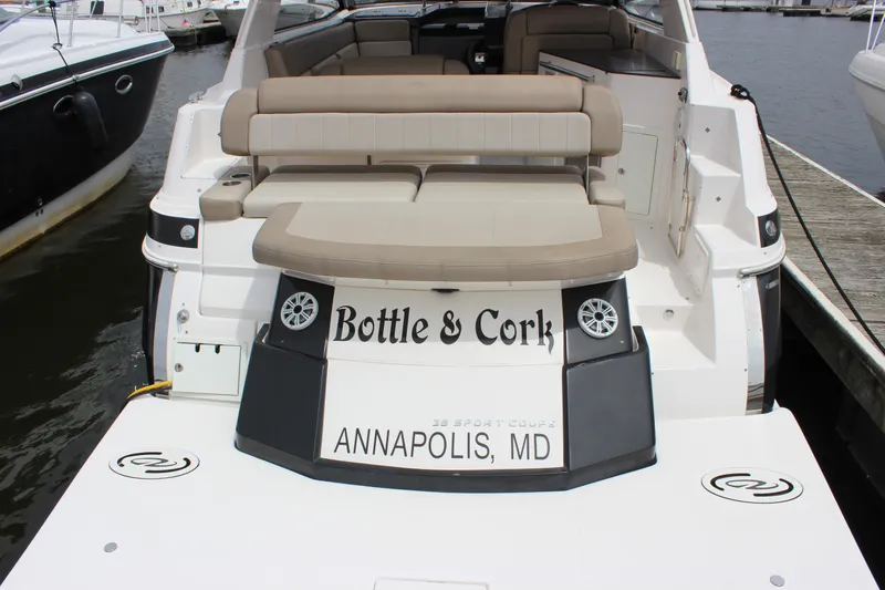 Slide: The Image of 2014 Regal 35 Sport Coupe docked, featuring "Bottle & Cork" name, Annapolis, MD. - 20