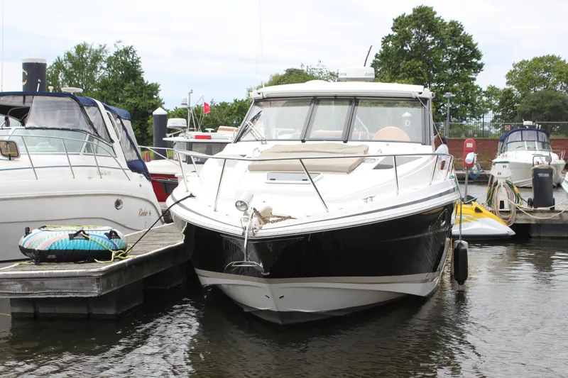 Slide: The Image of 2014 Regal 35 Sport Coupe docked at marina, surrounded by other boats. - 25