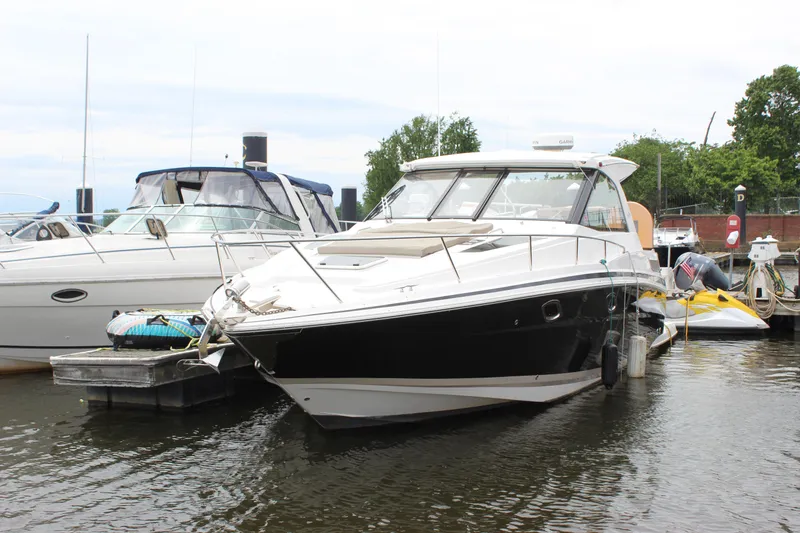 Slide: The Image of 2014 Regal 35 Sport Coupe docked at marina, surrounded by other boats. - 29