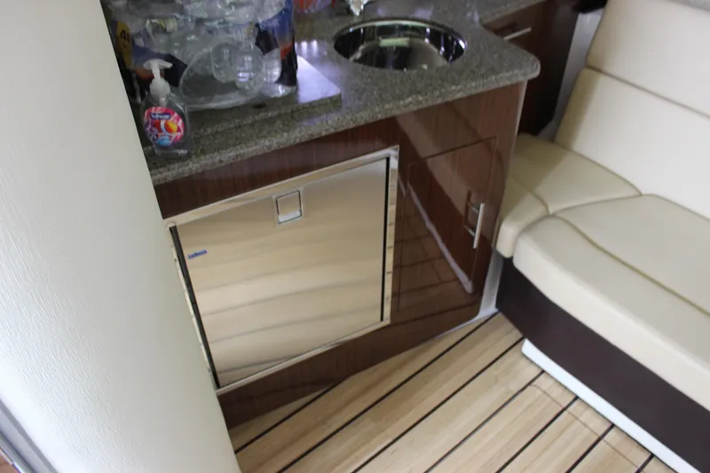 Slide: The Image of 2014 Regal 35 Sport Coupe interior with kitchenette and seating area. - 31