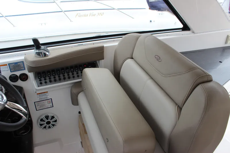 Slide: The Image of 2014 Regal 35 Sport Coupe interior with beige seating and control panel. - 4