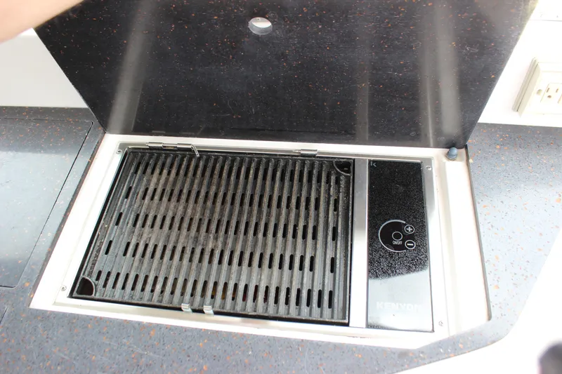 Slide: The Image of Built-in grill on 2014 Regal 35 Sport Coupe yacht, featuring sleek design and control panel. - 6