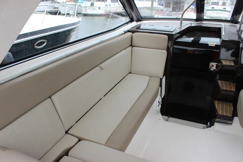 Slide: The Image of 2014 Regal 35 Sport Coupe interior with beige seating and sleek design. - 7