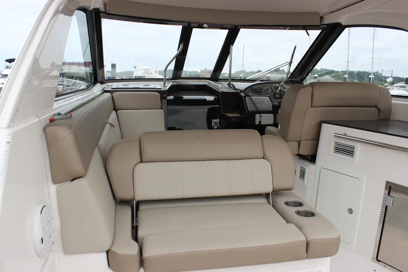 Slide: The Image of Interior of a 2014 Regal 35 Sport Coupe with beige seating and modern dashboard. - 8