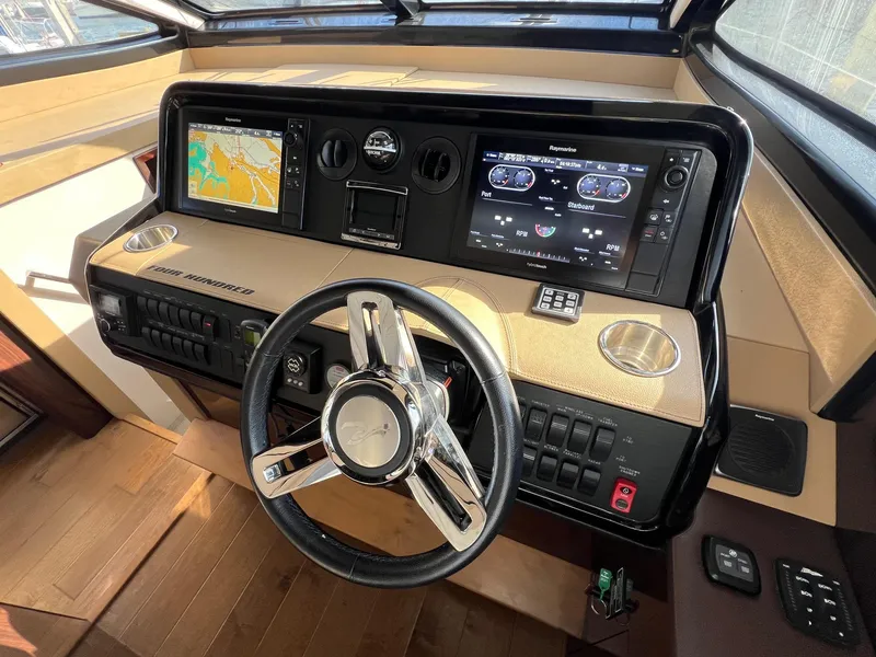 Slide: The Image of Control panel of 2017 Sea Ray Sundancer 400 yacht with navigation screens and steering wheel. - 17