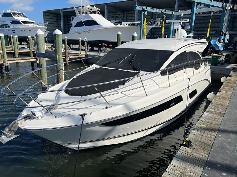 Slide: The Image of 2017 Sea Ray Sundancer 400 yacht docked at marina, sleek design, sunny day. - 20