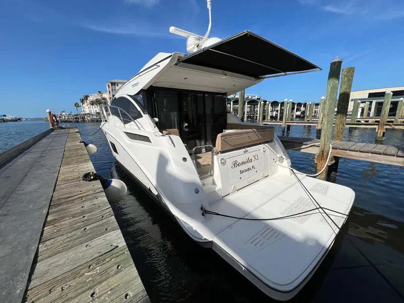 Slide: The Image of 2017 Sea Ray Sundancer 400 yacht docked at marina under clear blue sky. - 21