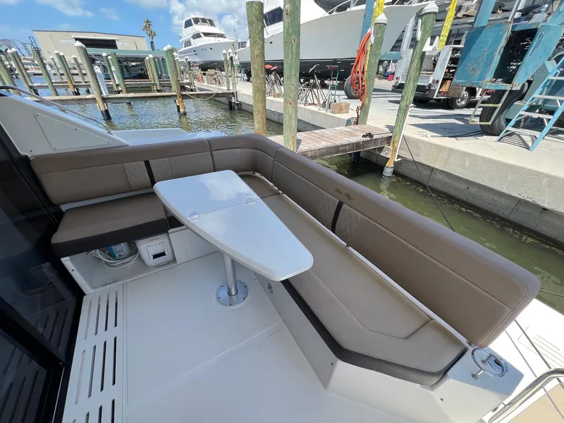 Slide: The Image of 2017 Sea Ray Sundancer 400 yacht with outdoor seating and table at marina. - 22