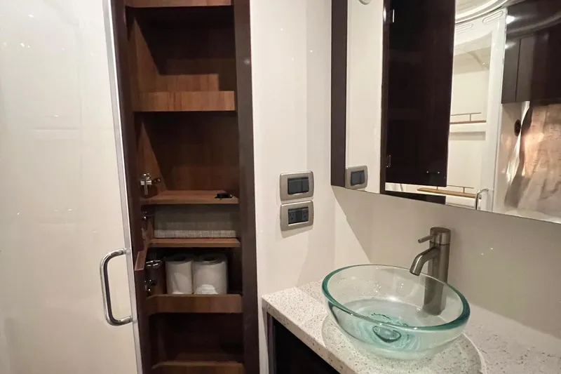 Slide: The Image of Luxurious bathroom in 2017 Sea Ray Sundancer 400 yacht with glass sink and wooden storage. - 27