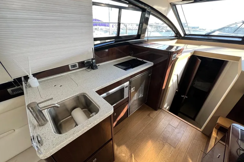 Slide: The Image of 2017 Sea Ray Sundancer 400 yacht interior with modern kitchen and sleek design. - 37