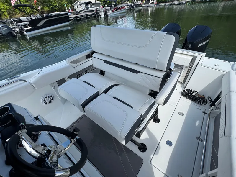 Slide: The Image of 2023 Blackfin 252 CC boat interior with white seating and steering wheel. - 10