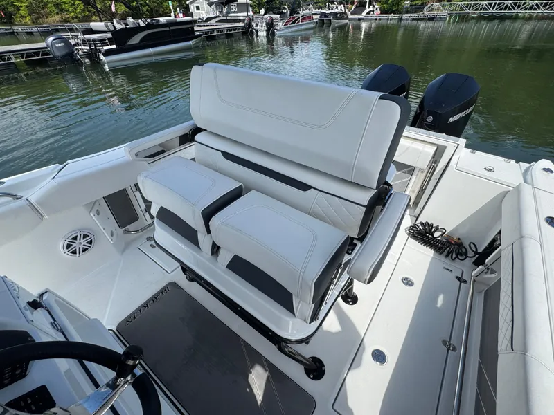 Slide: The Image of 2023 Blackfin 252 CC boat interior with dual seats and outboard motors. - 11