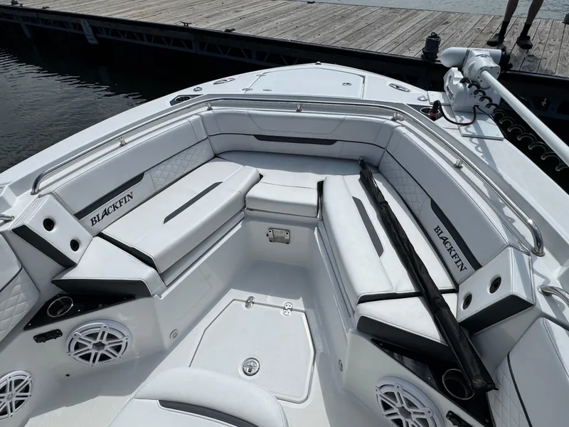 Slide: The Image of 2023 Blackfin 252 CC boat interior with cushioned seating and speakers. - 9