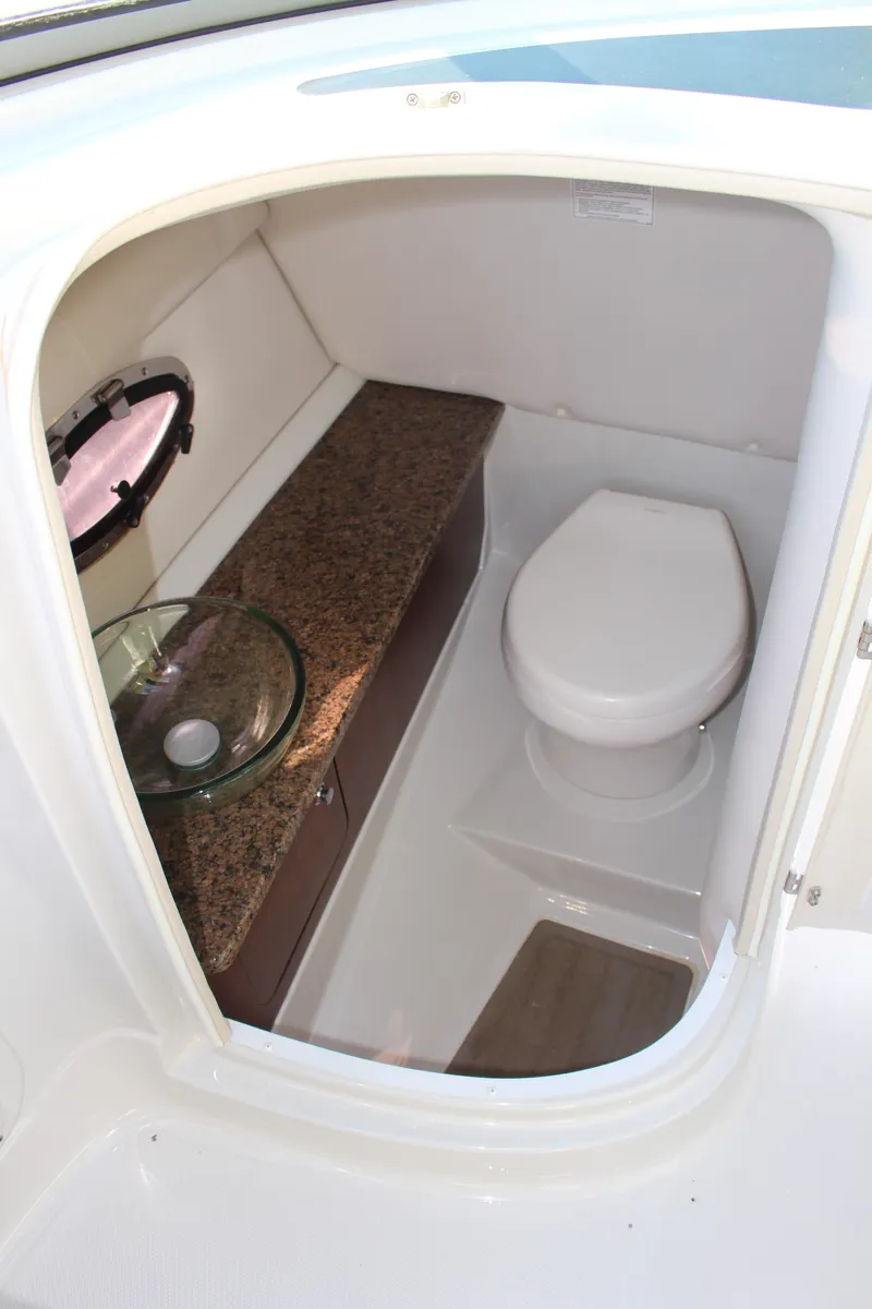 Slide: The Image of 2019 Crownline Eclipse E285 XS boat bathroom with toilet and sink. - 10