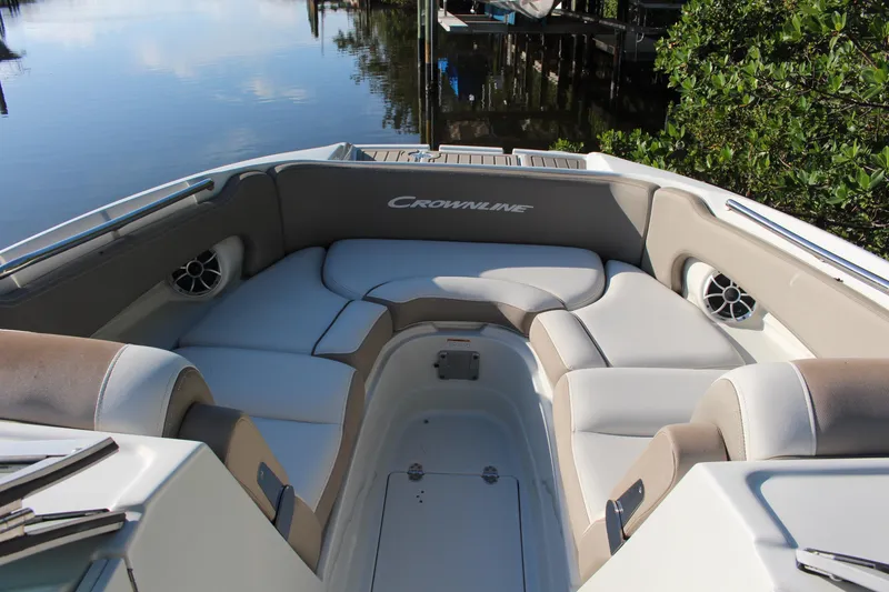 Slide: The Image of 2019 Crownline Eclipse E285 XS boat interior with cushioned seating and sleek design. - 5