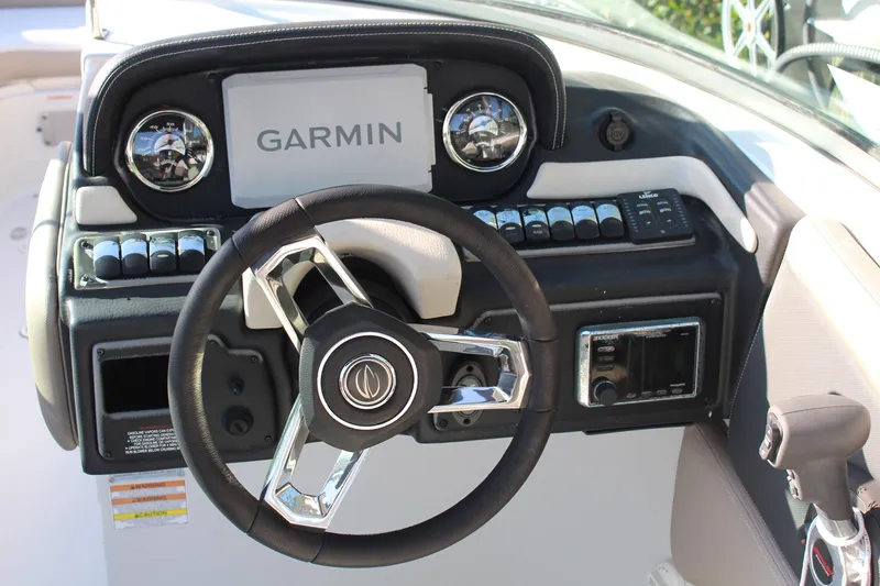 Slide: The Image of Steering wheel and dashboard of 2019 Crownline Eclipse E285 XS boat with Garmin display. - 8