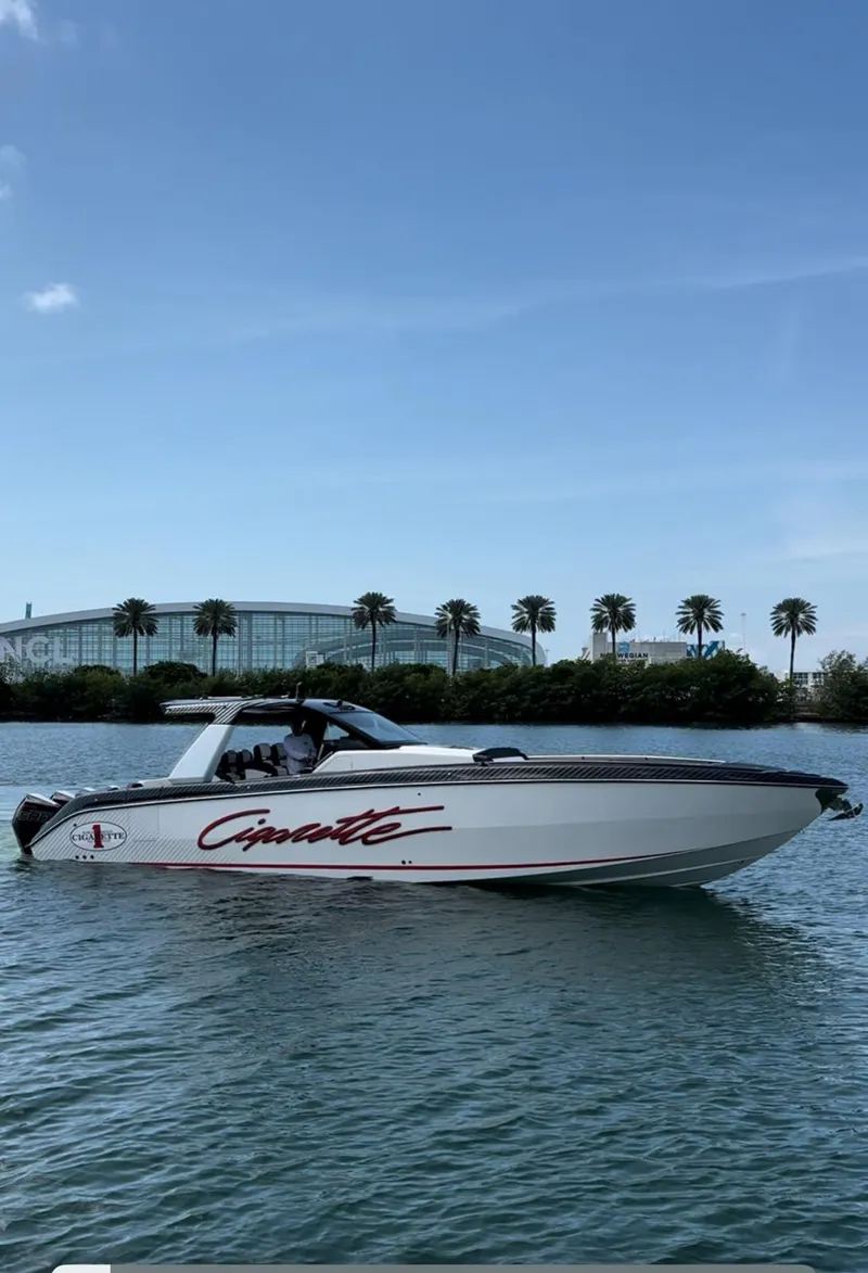 Slide: The Image of 2024 Cigarette 42 Auroris boat on water with palm trees in background. - 1