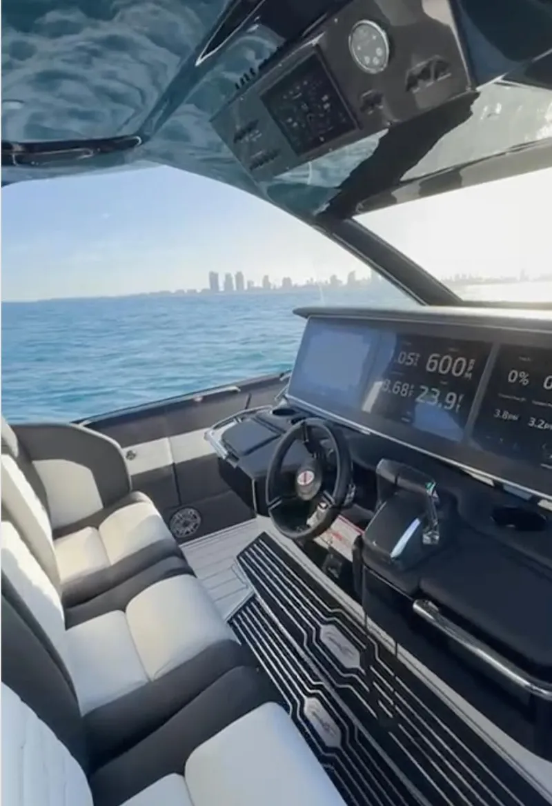 Slide: The Image of 2024 Cigarette 42 Auroris luxury boat interior with modern dashboard and ocean view. - 7