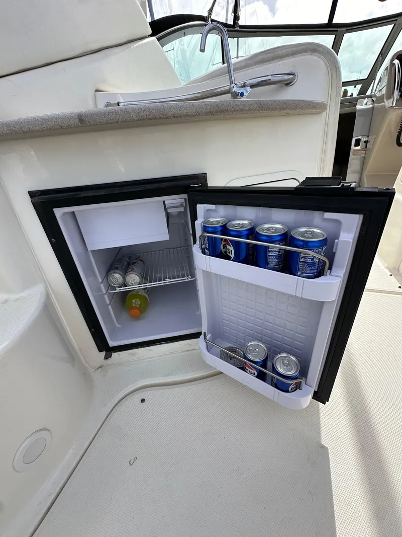 Slide: The Image of Mini fridge stocked with drinks on a 2003 Sea Ray 320 Sundancer boat. - 13