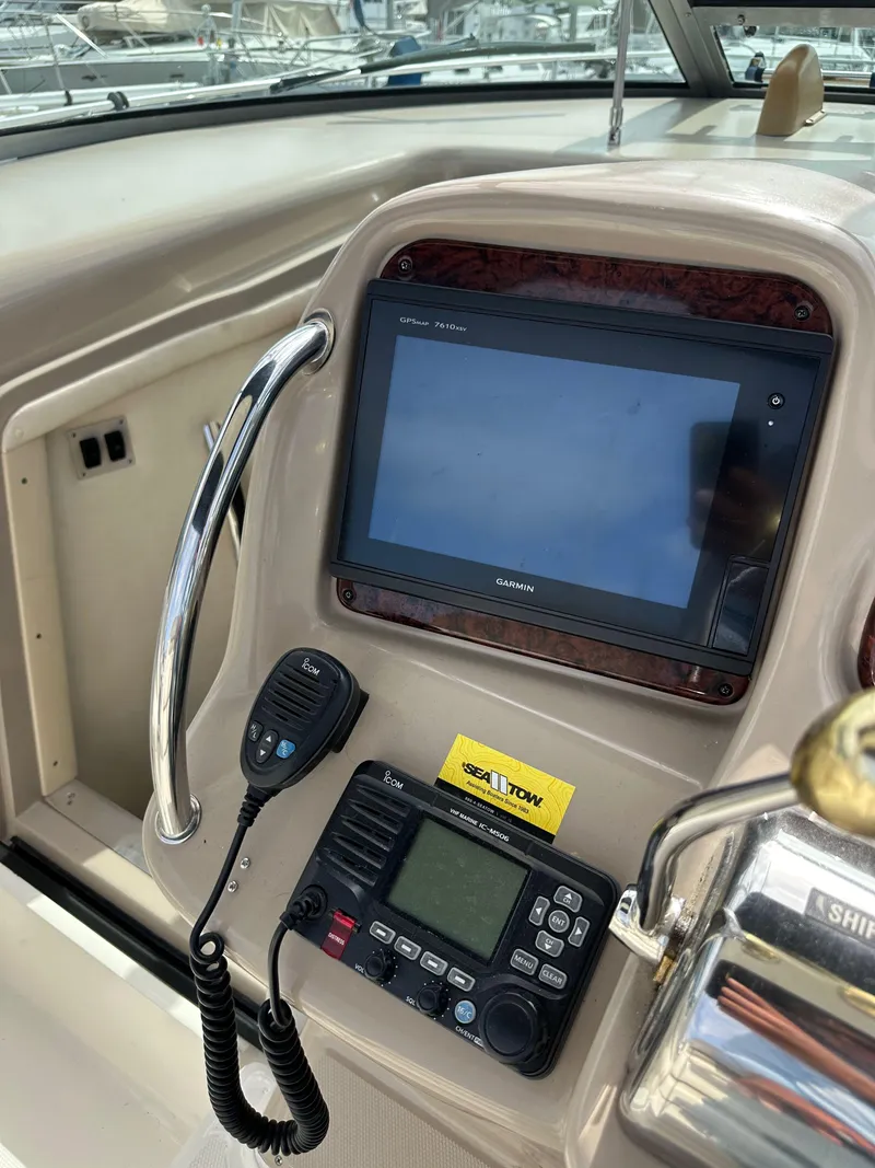 Slide: The Image of 2003 Sea Ray 320 Sundancer dashboard with navigation and communication equipment. - 18