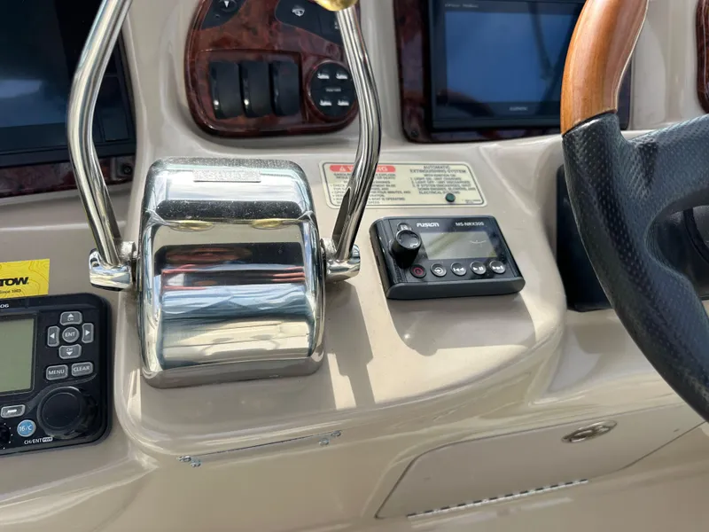 Slide: The Image of Control panel of a 2003 Sea Ray 320 Sundancer boat with throttle and navigation controls. - 19
