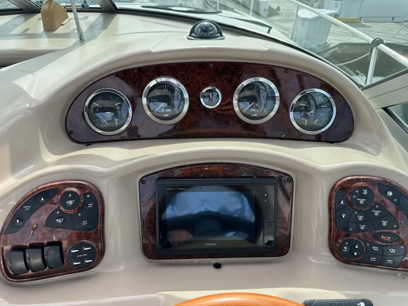 Slide: The Image of 2003 Sea Ray 320 Sundancer dashboard with gauges and control panels. - 20