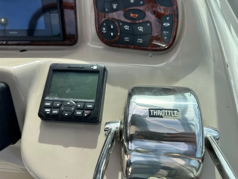 Slide: The Image of Control panel of 2003 Sea Ray 320 Sundancer with throttle and navigation display. - 21
