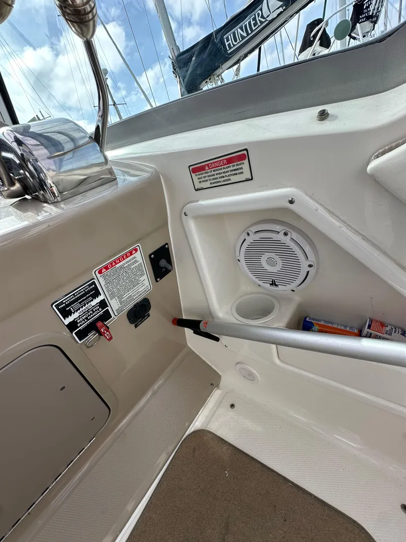 Slide: The Image of 2003 Sea Ray 320 Sundancer boat interior with control panel and speaker. - 22