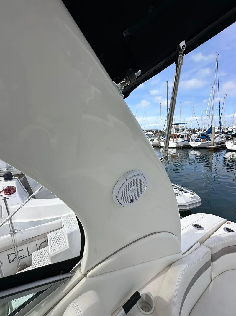 Slide: The Image of 2003 Sea Ray 320 Sundancer interior with marina view and speaker detail. - 23