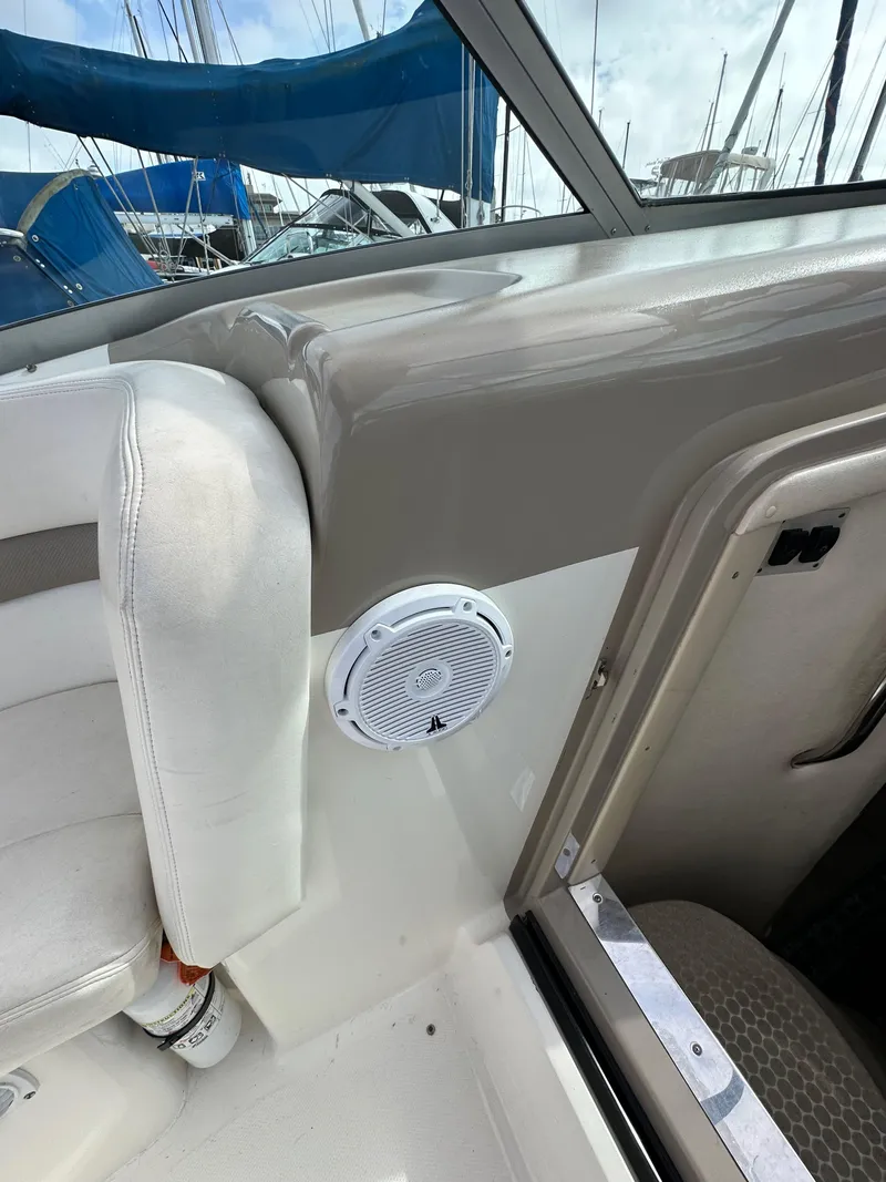 Slide: The Image of 2003 Sea Ray 320 Sundancer interior with speaker and seating detail. - 24