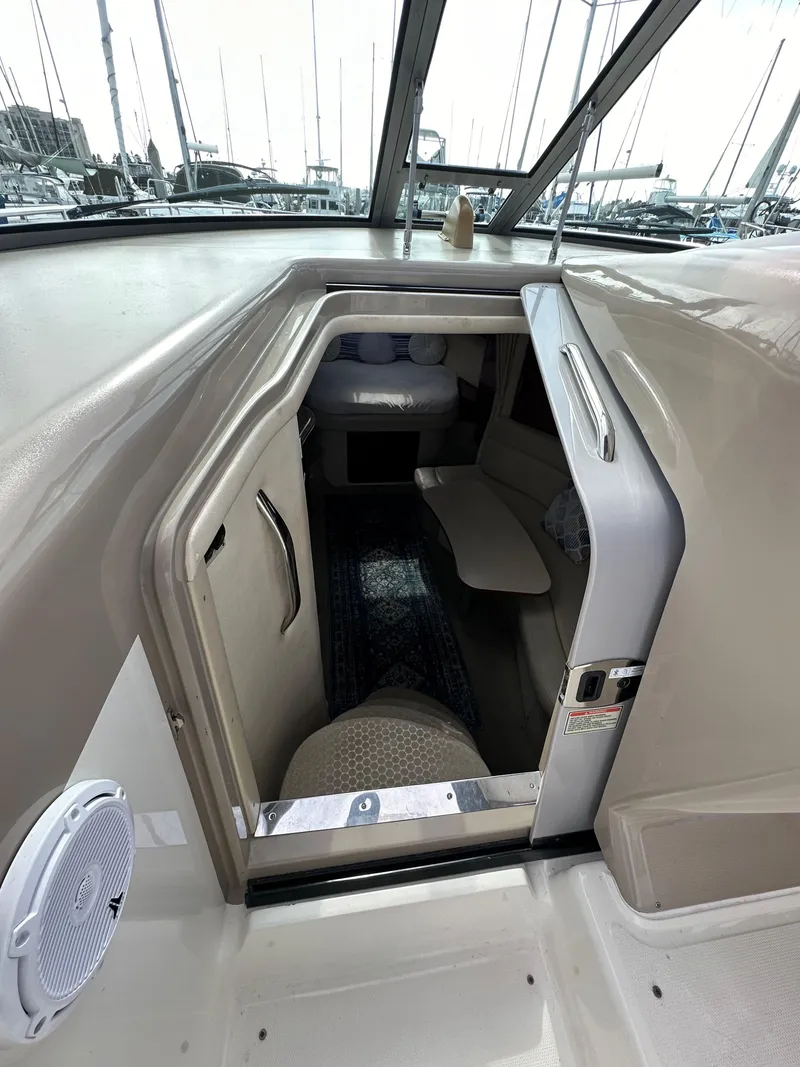 Slide: The Image of 2003 Sea Ray 320 Sundancer cabin entrance with seating and interior view. - 25