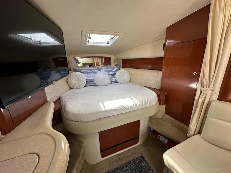 Slide: The Image of Interior of 2003 Sea Ray 320 Sundancer with cozy bed and elegant wood finish. - 38
