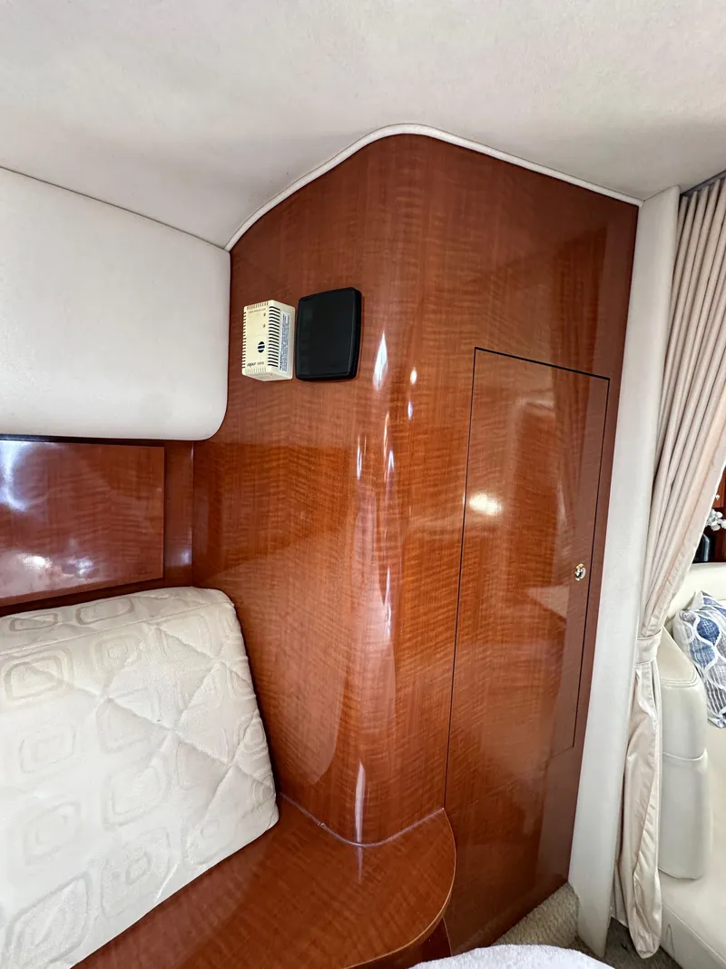 Slide: The Image of Interior of 2003 Sea Ray 320 Sundancer with wood paneling and cushioned seating. - 39