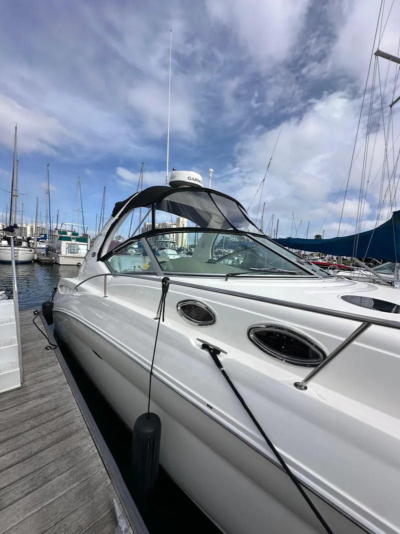 Slide: The Image of 2003 Sea Ray 320 Sundancer docked at marina under cloudy sky. - 4
