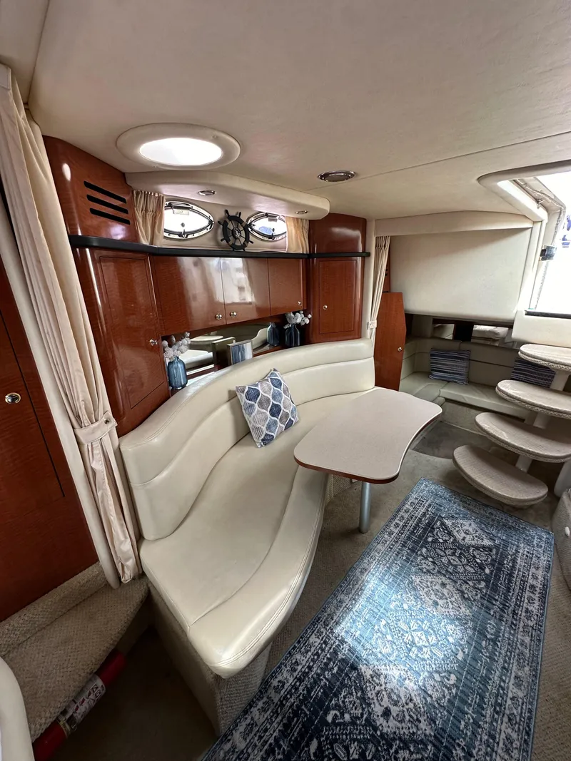 Slide: The Image of 2003 Sea Ray 320 Sundancer interior with elegant seating, table, and stylish decor. - 41