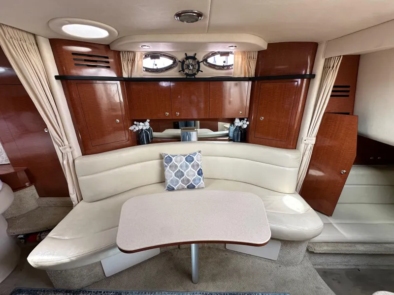 Slide: The Image of Interior of 2003 Sea Ray 320 Sundancer with elegant seating and wooden cabinetry. - 43
