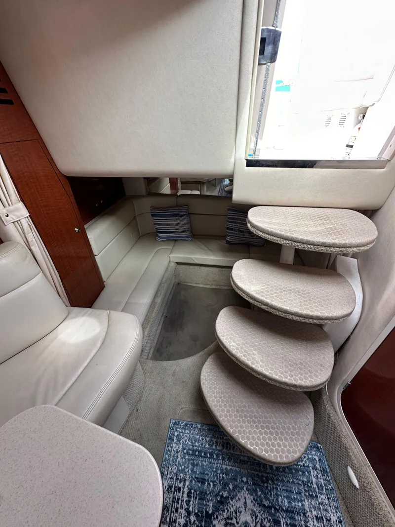 Slide: The Image of Interior of 2003 Sea Ray 320 Sundancer with curved steps and seating area. - 44