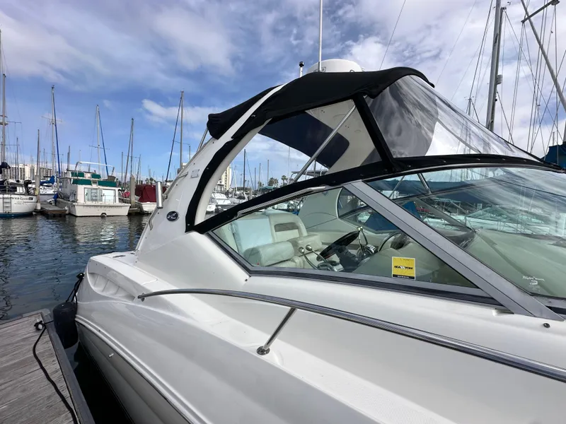 Slide: The Image of 2003 Sea Ray 320 Sundancer docked at marina under blue sky. - 5
