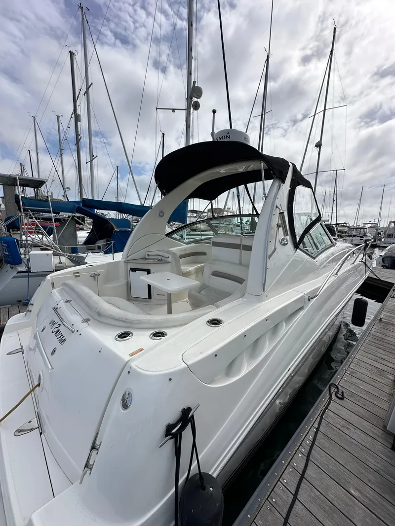 Slide: The Image of 2003 Sea Ray 320 Sundancer docked at marina under cloudy sky. - 6