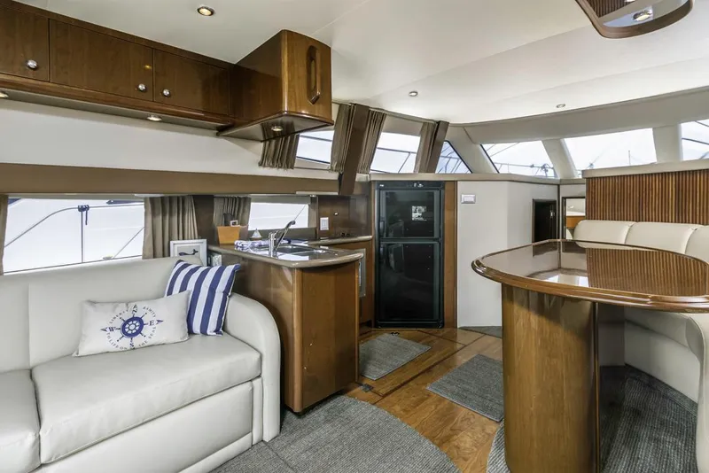 Slide: The Image of Luxurious interior of 2007 Carver 42 Super Sport yacht with modern kitchen and seating area. - 16