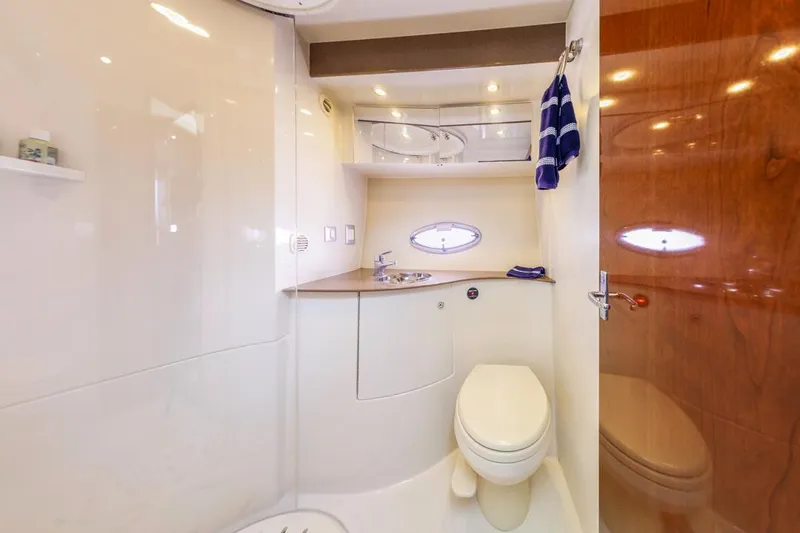 Slide: The Image of 2007 Carver 42 Super Sport yacht bathroom with modern fixtures and wooden accents. - 18