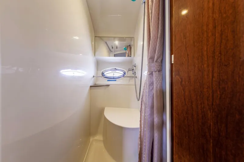 Slide: The Image of Bathroom interior of 2007 Carver 42 Super Sport yacht with shower and porthole window. - 19