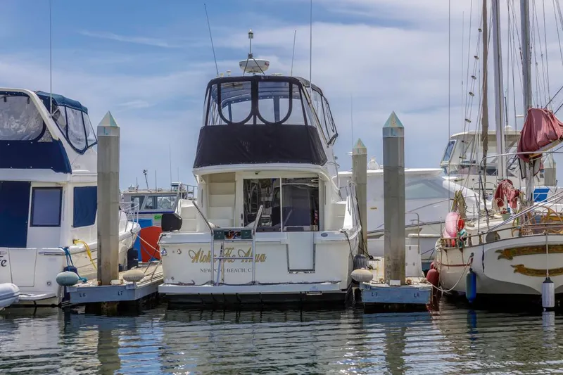 Slide: The Image of 2007 Carver 42 Super Sport yacht docked at marina under clear sky. - 2