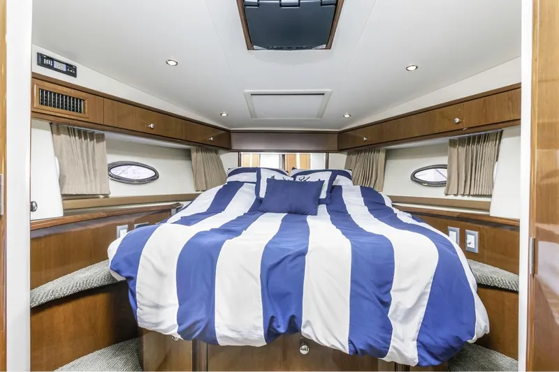 Slide: The Image of Luxurious cabin interior of 2007 Carver 42 Super Sport yacht with striped bedding. - 20
