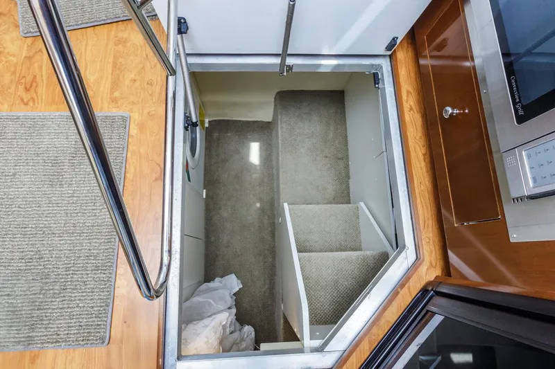 Slide: The Image of Interior view of 2007 Carver 42 Super Sport yacht showing carpeted stairs and wooden flooring. - 24
