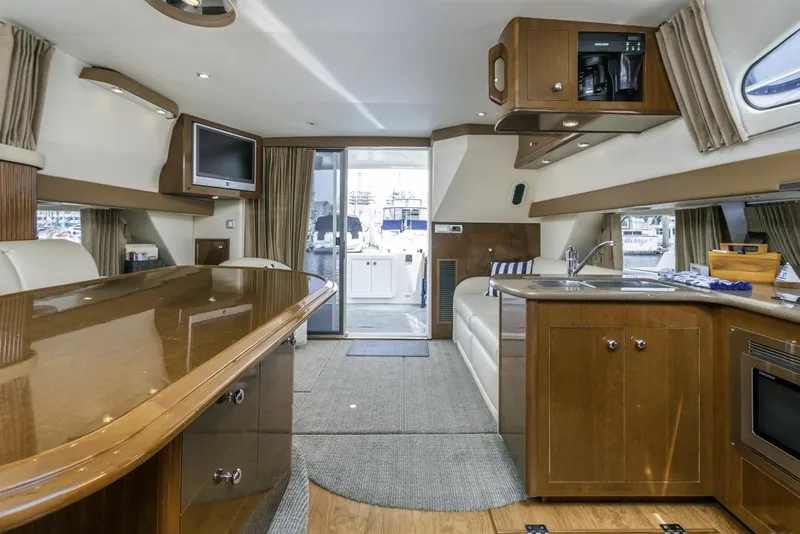 Slide: The Image of Luxurious interior of 2007 Carver 42 Super Sport yacht with modern kitchen and seating area. - 26